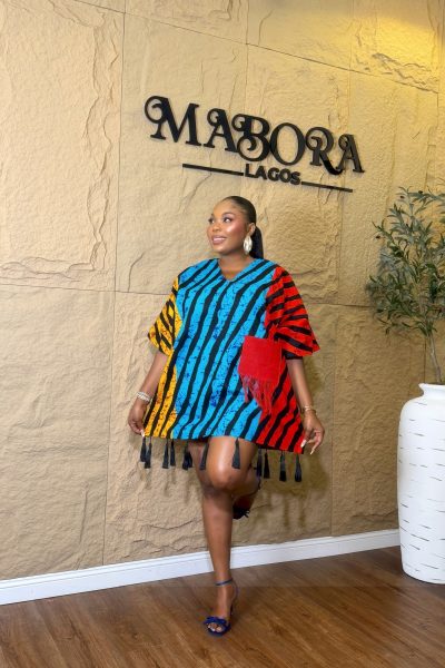 Model wearing Tassels Bubu vibrant multi-color ready-to-wear short dress with fringe pocket and tassel hem.