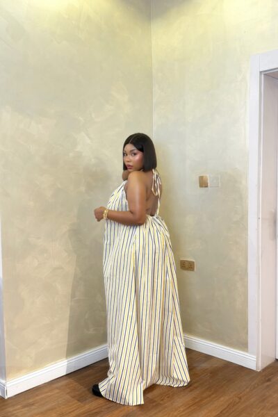 Woman wearing the Baddie Maxi striped halter-neck maxi dress with an elegant open-back design.
