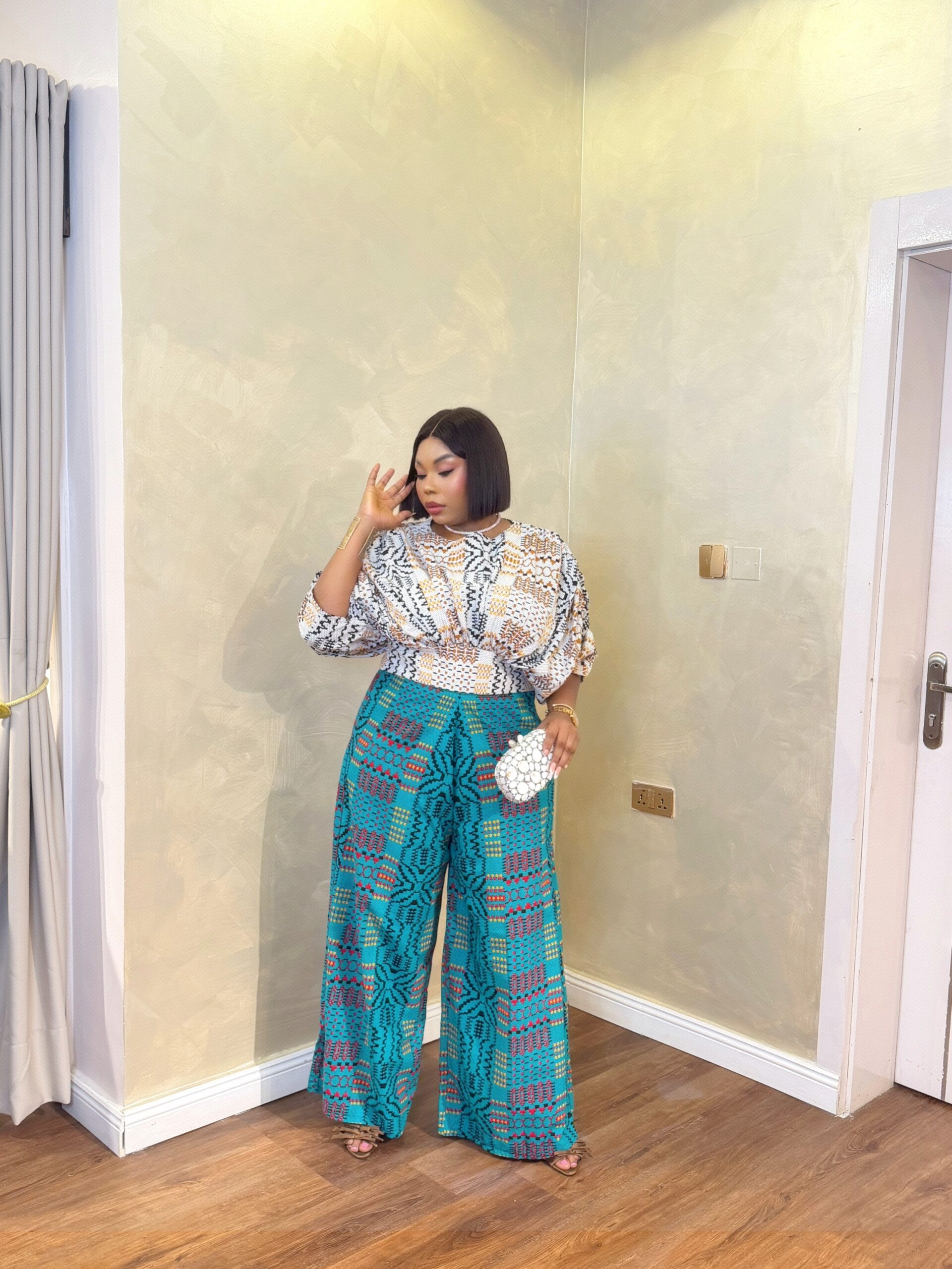 Elegant Ankara Pant Set for Women featuring vibrant wide-leg African print trousers and a stylish patterned top.