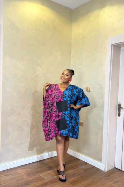Woman wearing a pink and blue floral Short Eko Bubu with black pockets