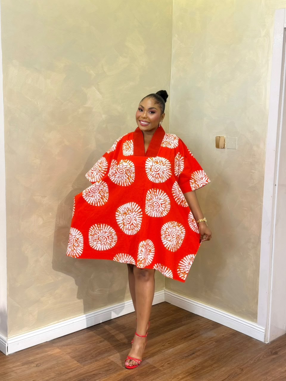 Woman wearing a red and white Short Eko Bubu with open-back detail