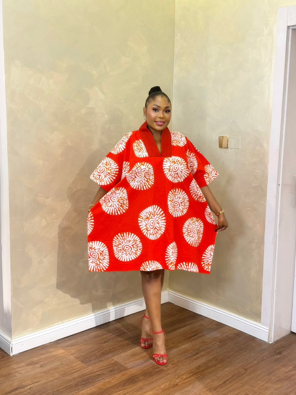 Woman wearing a red and white Short Eko Bubu with open-back detail
