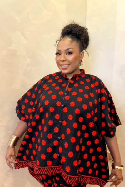 Woman wearing a black and red African print maxi short set