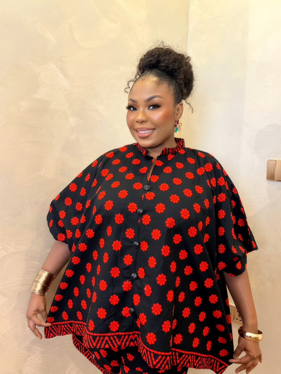Woman wearing a black and red African print maxi short set