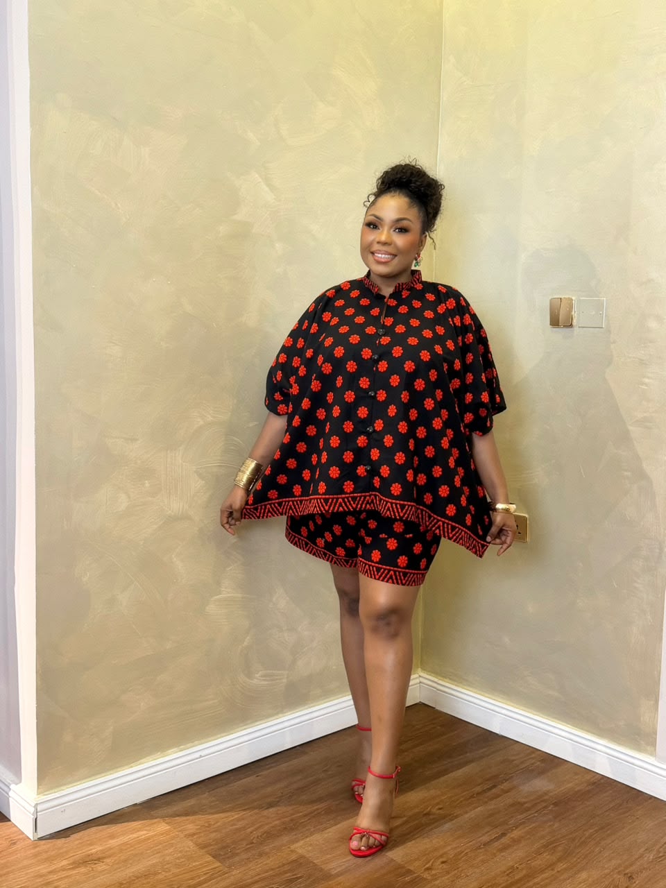 Woman wearing a black and red African print maxi short set