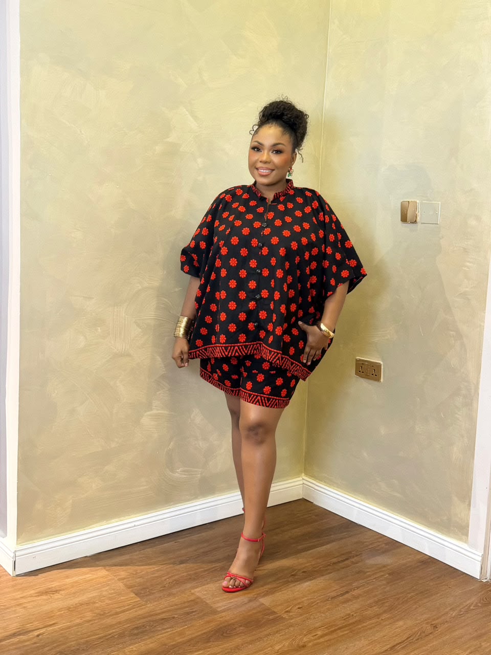 Woman wearing a black and red African print maxi short set